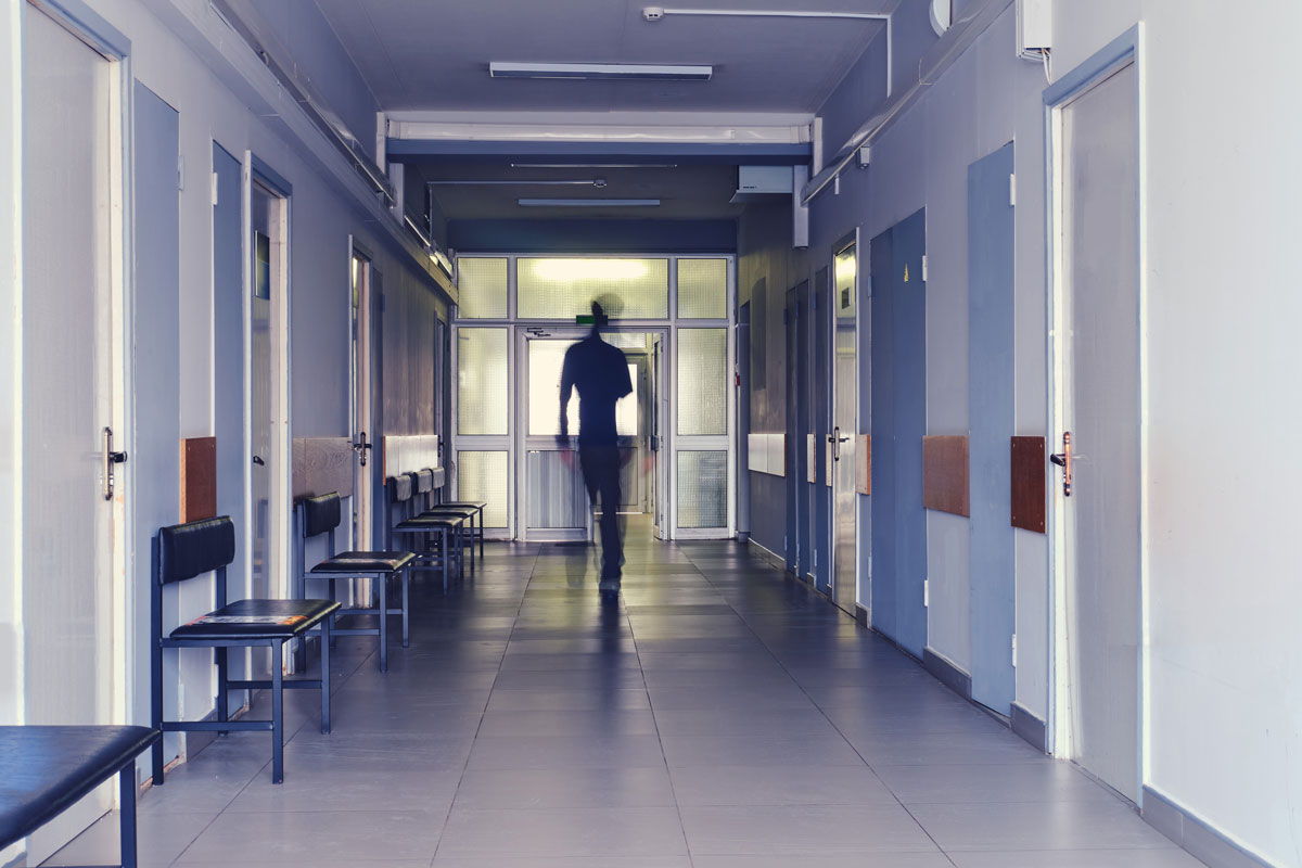 Getty Image of hospital hallway with person far down the hall