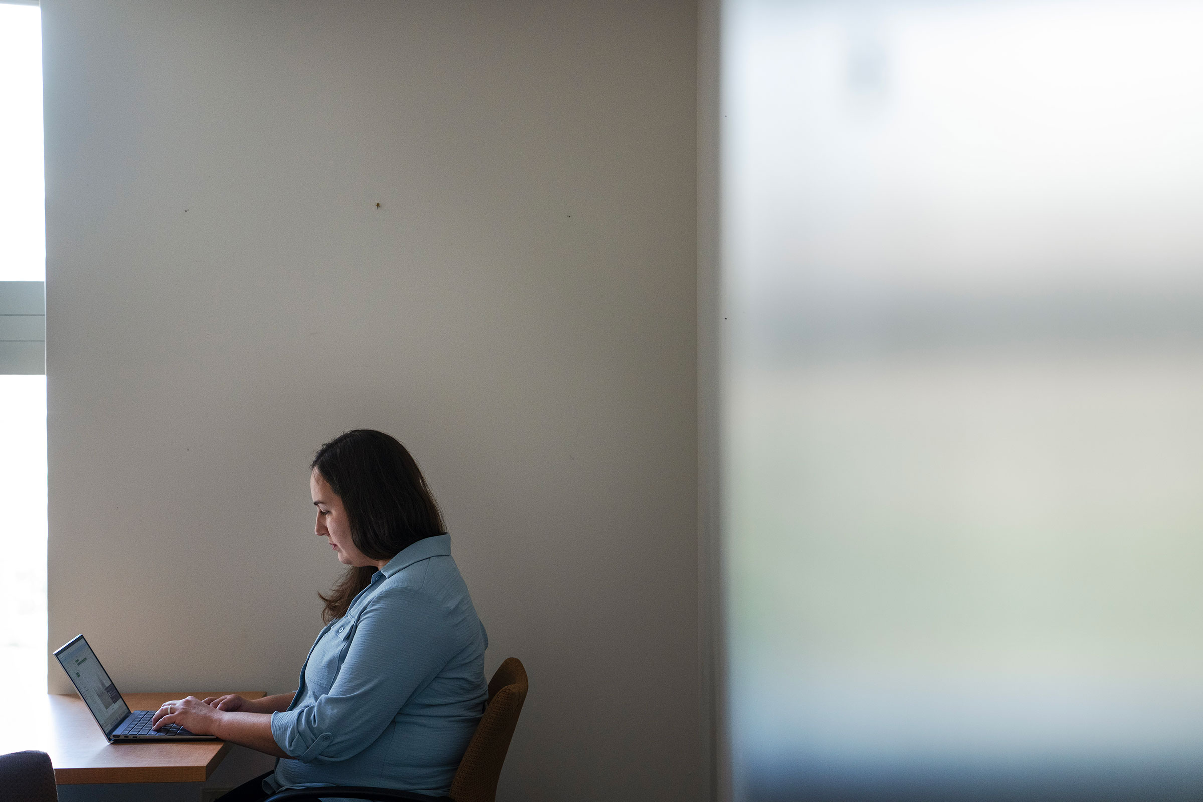 A woman works on her computer