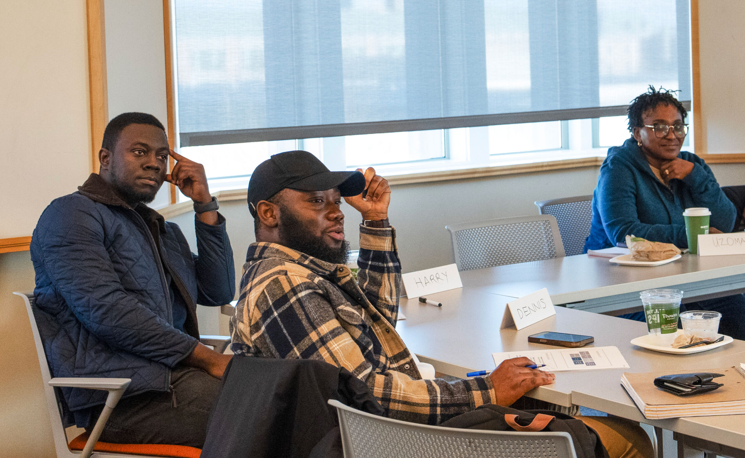 Three MPH students in a classroom learning about teaching.