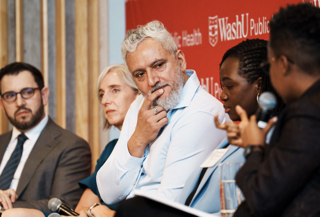 Panelists on a stage to listen to a question from the moderator.