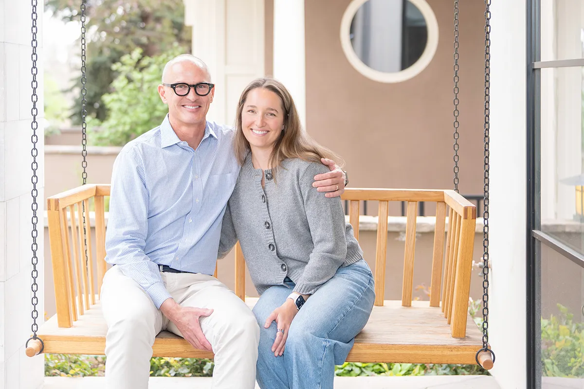 Man and adult daughter sitting on a porch swing